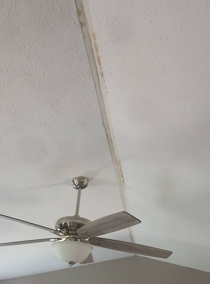 Damaged ceiling corner seam before repair