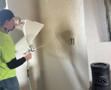 Spraying knockdown texture on an interior wall